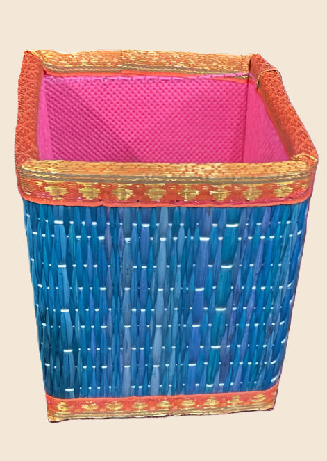 Colorful woven basket with pink interior on a beige background